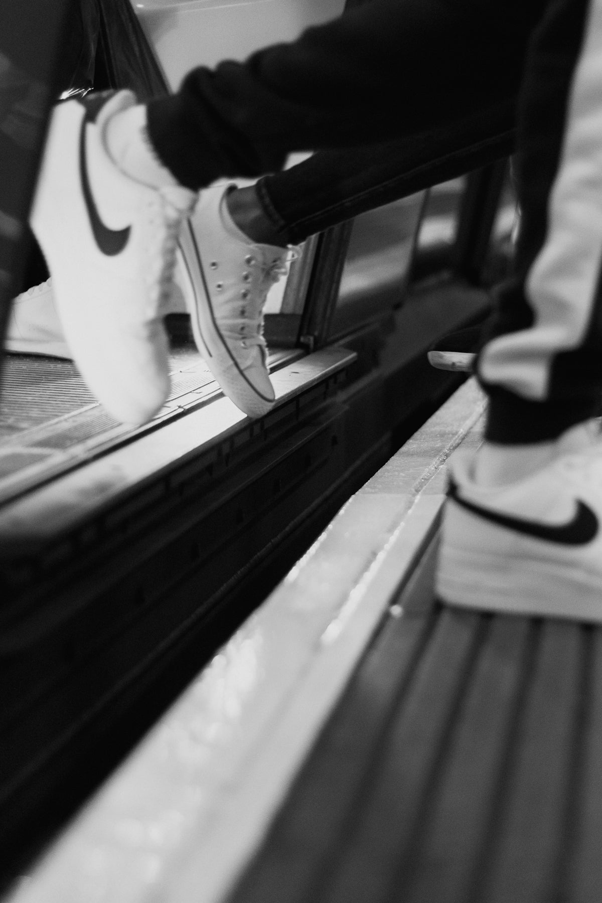 person wearing white nike sneakers